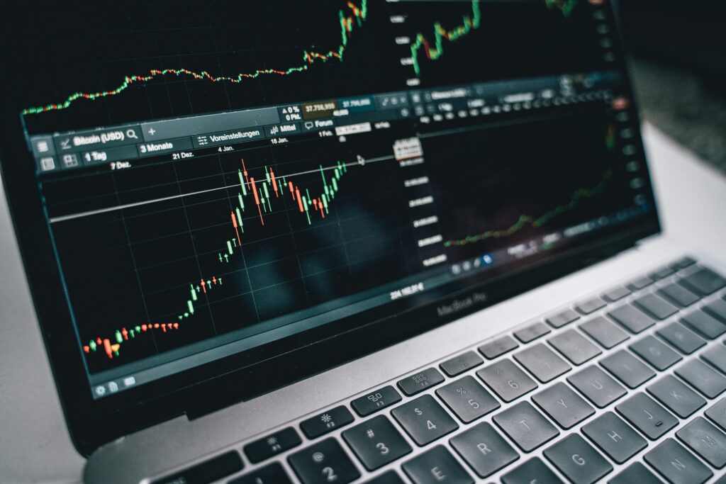 Close-up of a laptop screen showing a candlestick chart, symbolizing digital trade and technology growth.